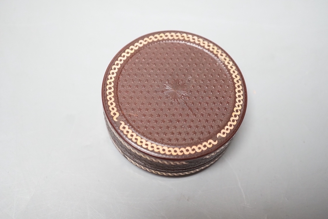 A 19th century pressed bois durci and gilt metal snuff box with painted miniature portrait of a gentleman on ivory to cover. 6cm diameter